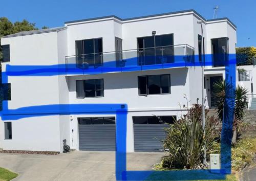 a white house with blue trim at 379 on Kāpiti in Paraparaumu