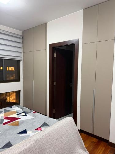 a bedroom with a bed and a room with a fireplace at Monoambiente en sopocachi in La Paz