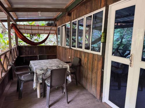 a table and chairs on the porch of a house at Donde Sergio - Acantilados in Buenaventura