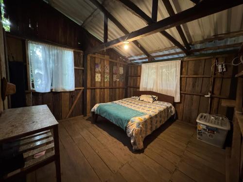 a bedroom with a bed in a wooden room at Donde Sergio - Acantilados in Buenaventura