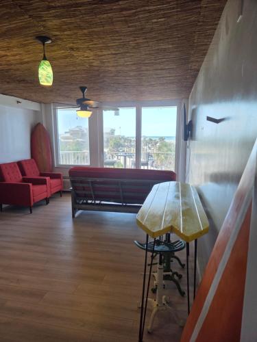 a waiting room with a bench and a table at The Surf Shack at Harbour Beach Resort in Daytona Beach