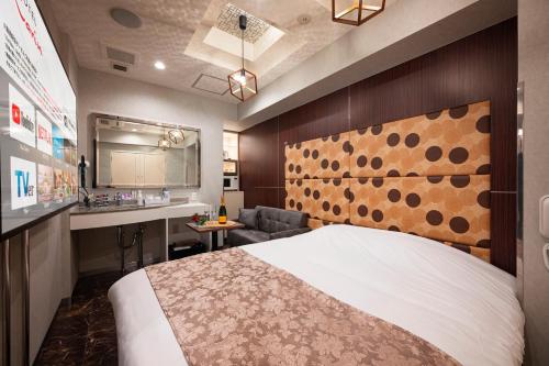 a hotel room with a bed and a sink at HOTEL Karin in Tokyo