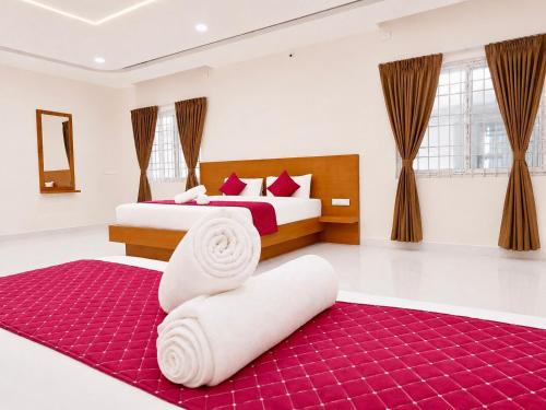 a bedroom with two beds and a red rug at K V Comforts in Chikmagalūr
