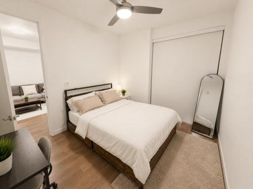a bedroom with a bed and a desk and a mirror at Glendale Luxe Stays - Downtown in Glendale