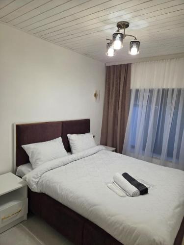 a bedroom with a large bed with two towels on it at A-frame-WHITE HOUSE-II in Qusar