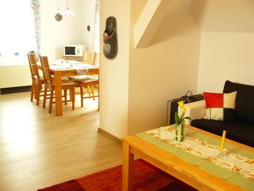 a living room with a couch and a table at Ferienwohnung Sauer in Wöhrden