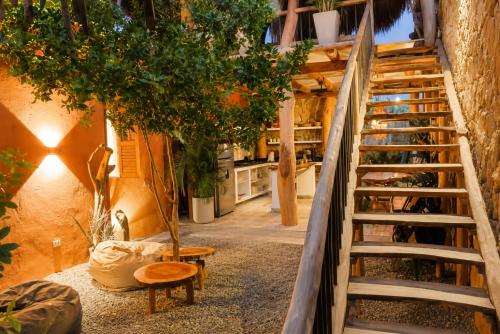 a staircase leading up to a room with a tree at Las Dunas Beach house en Santa veronica cerca a la playa in Juan de Acosta