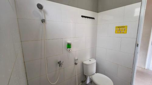 a white bathroom with a shower and a toilet at Jolotundo Glamping and Edupark in Sagi