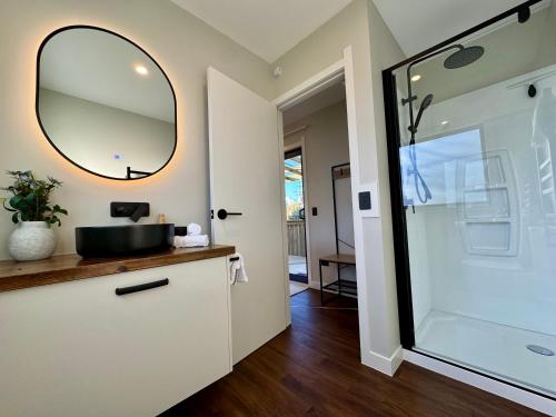 a bathroom with a sink and a mirror at Modern Mountain Retreat in Ohakune