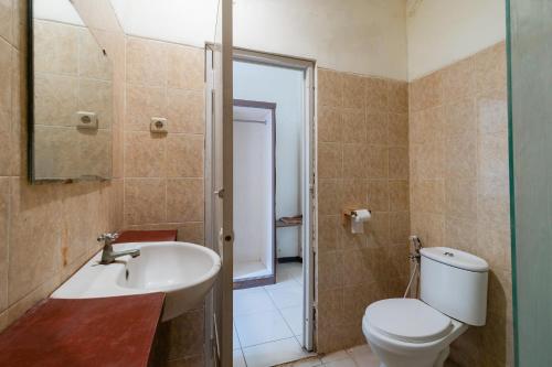 a bathroom with a toilet and a sink at RedDoorz near Gubeng Station Surabaya in Bagongpatar