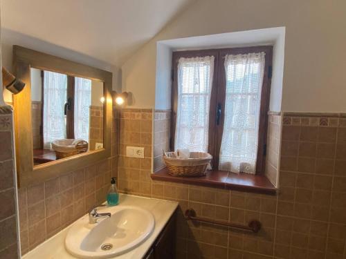 a bathroom with a sink and two windows at Detached 4 Bedroom Villa with Pool in Valencia de Alcántara