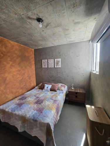 a bedroom with a bed and a wooden table at Loft type apartment premium style with pool in Barranquilla