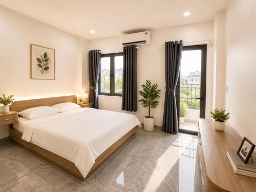 a bedroom with a large bed and windows at Samaki Home in Ho Chi Minh City