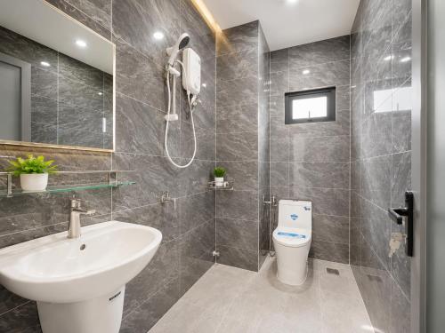 a bathroom with a sink and a toilet and a shower at Samaki Home in Ho Chi Minh City