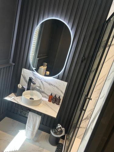 a bathroom with a sink and a mirror at Bromielaw Room Only Accommodation in Seahouses