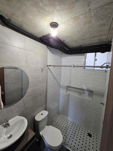 a bathroom with a shower and a toilet and a sink at Loft type apartment premium style with pool in Barranquilla