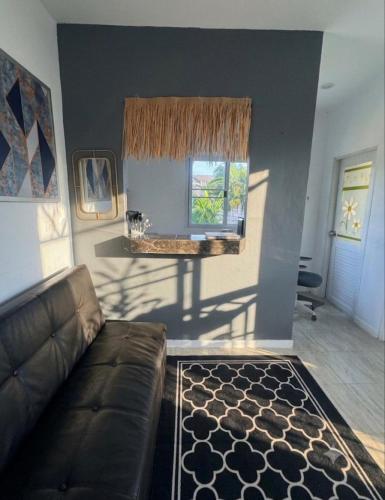a living room with a couch and a window at Sunset tiny house near fisherman village in Bophut