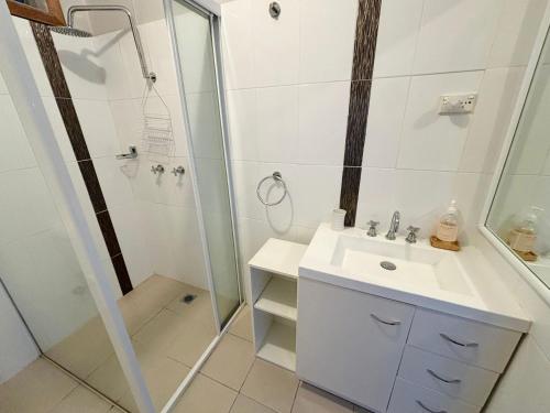 a bathroom with a shower and a sink at Our Place in South West Rocks