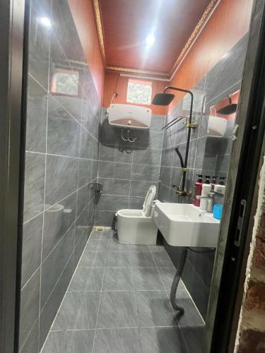 a bathroom with a sink and a toilet at A thám homesstay in Dam Thuy