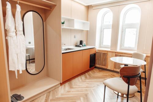 a kitchen with a table and a mirror at Sansar Hotel Erdenet in Erdenet