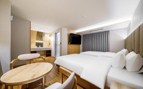 a hotel room with a bed and a table at d hotel in Seoul