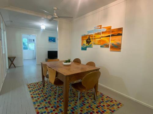 a dining room with a wooden table and chairs at The Barracks Arcadia 1 in Arcadia