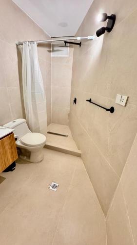 a bathroom with a toilet and a shower at Hotel Sunset Mar in Lima