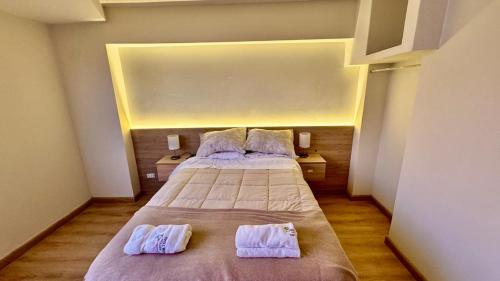a bedroom with two beds with towels on them at Hotel Sunset Mar in Lima