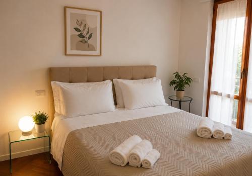 a bedroom with a bed with two towels on it at Residence MareVerde in Senigallia