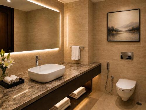 a bathroom with a sink and a toilet at Sapphire Hotel & Convention Centre in Baddi
