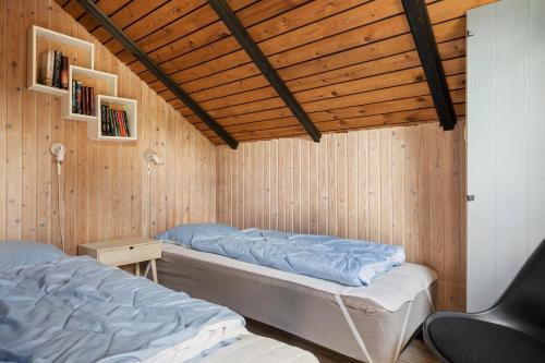 a bedroom with two beds and a wooden ceiling at Mtb Beach Peace Holiday By The Dunes in Fjerritslev
