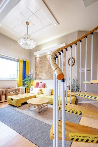 a living room filled with furniture and a chandelier at Young Stay in Seoul