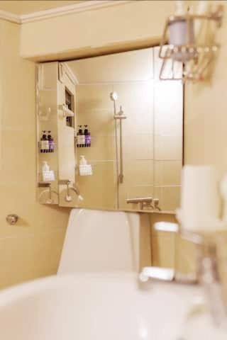 a bathroom mirror with a sink and a shower at Young Stay in Seoul