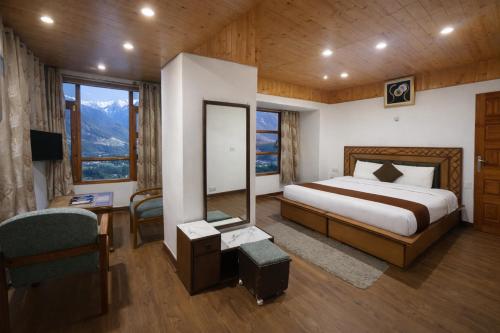 a bedroom with a bed and a desk and window at The Himalayan Nomad Manali - 2 bedrooms mountain view independent villas with personal lawn in Manāli