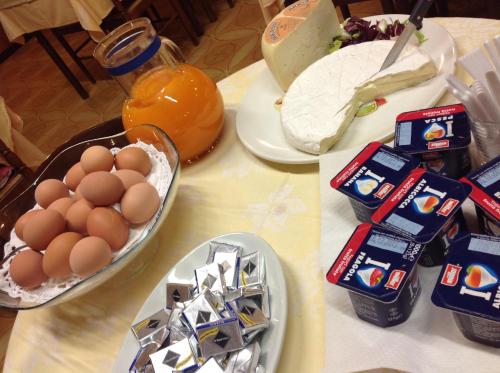 a table with eggs and other food on it at Ristorante Albergo Roma in Legnano