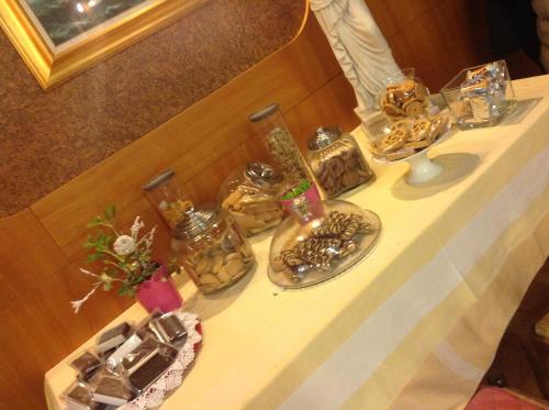 a table with a bunch of vases on it at Ristorante Albergo Roma in Legnano
