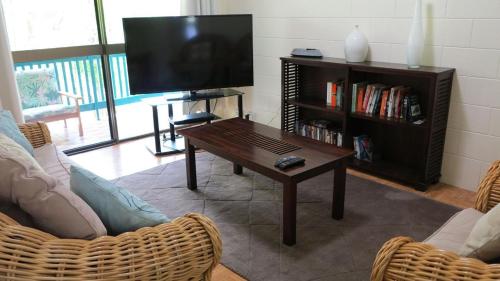 a living room with a television and a coffee table at Magnetic Reef 7 in Arcadia
