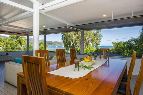 a dining room with a table and a view of the ocean at On the Beach in Horseshoe Bay