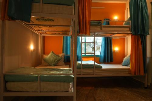 a room with three bunk beds in it at Hostel Mama in Udaipur