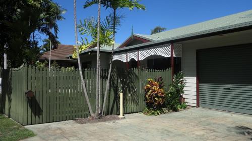 a house with a fence and a garage at Arcadia Gardens in Arcadia