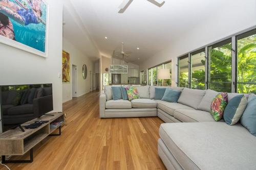 a living room with a couch and a table at Whispering Palms in Nelly Bay
