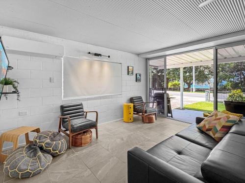 a living room with a couch and a projection screen at Island View Apt 1 in Arcadia
