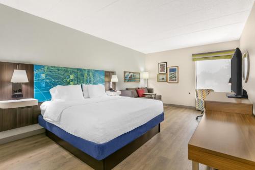 a hotel room with a large bed and a desk at Hampton Inn Richmond KY in Richmond