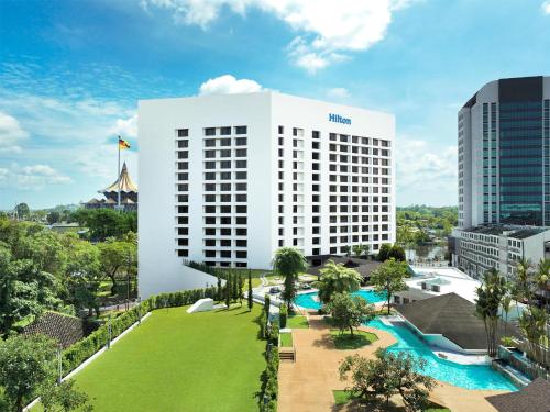 an aerial view of a hotel with a large white building at Hilton Kuching Hotel in Kuching