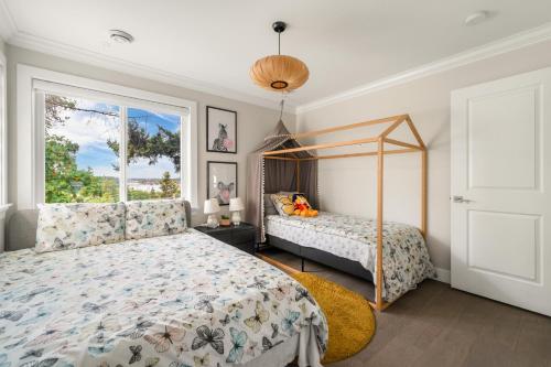 a bedroom with a bed and a window at 5-Star Luxury and comfortable home in New Westminster