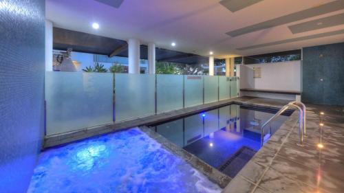 a swimming pool with blue lights in a house at Maggies Beachfront Apartment 6 in Horseshoe Bay