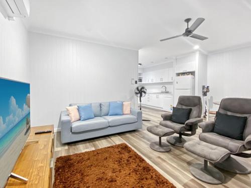 a living room with a couch and two chairs at Magnetic Reef Unit 2 in Arcadia