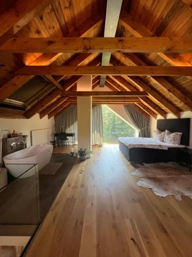 a bedroom with a bed and a tub in a room at chata Jarka in Jivno