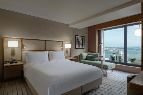 a hotel room with a bed and a large window at Doubletree By Hilton Istanbul Macka in Istanbul