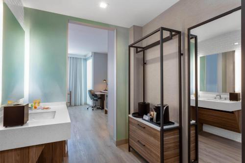 a bathroom with a sink and a mirror at Wyndham Garden Miami International Airport in Miami